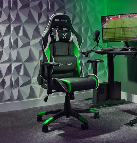 Gaming chair with X rocker branding in a room with a computer setup.