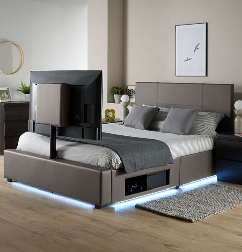 Modern bed with TV above in a bedroom setting
