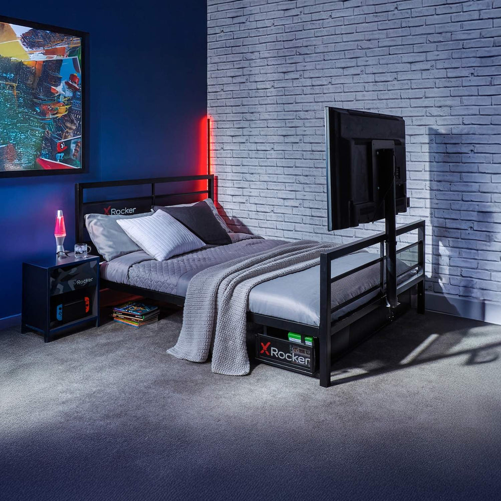 Modern bedroom with a bed, nightstands, and a TV against a brick wall.