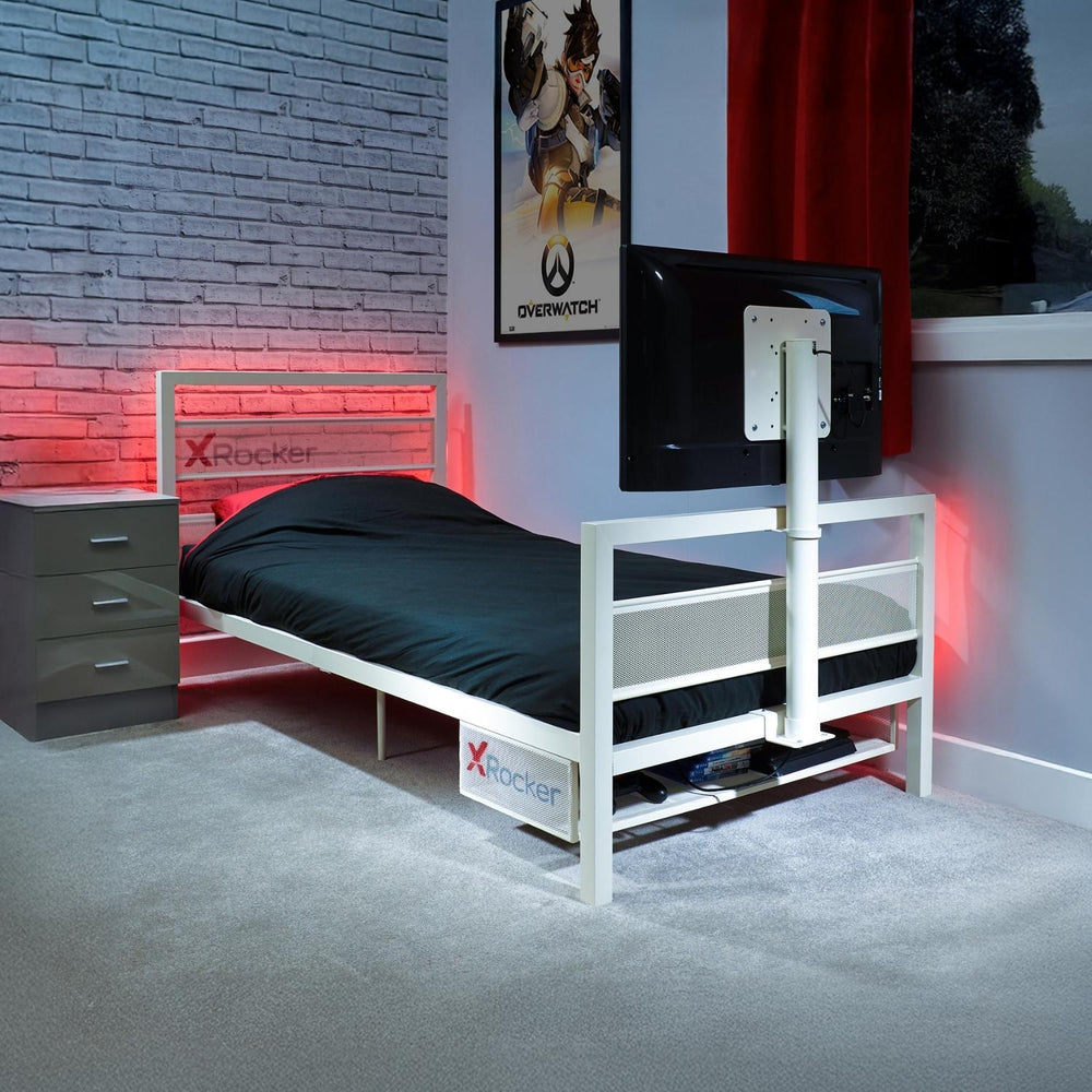 Bed with X rocker branding in a room setting with a TV and gaming decor.