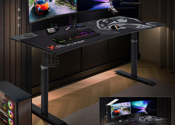 Gaming desk with multiple monitors and gaming accessories in a dimly lit room.