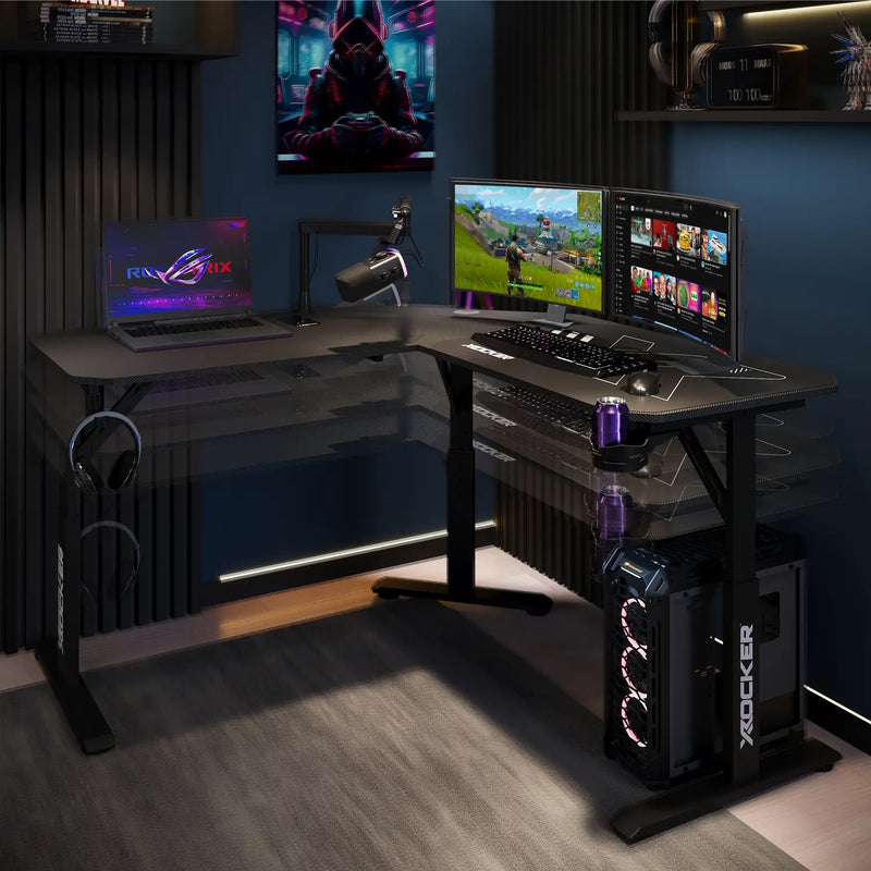 Cougar XL Gaming setup with computer monitors, laptop, and gaming equipment in a room.