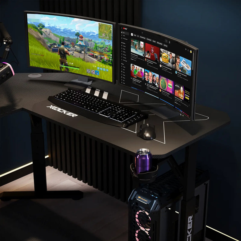 Gaming setup with dual monitors, keyboard, mouse, and a can on a X rocker desk.