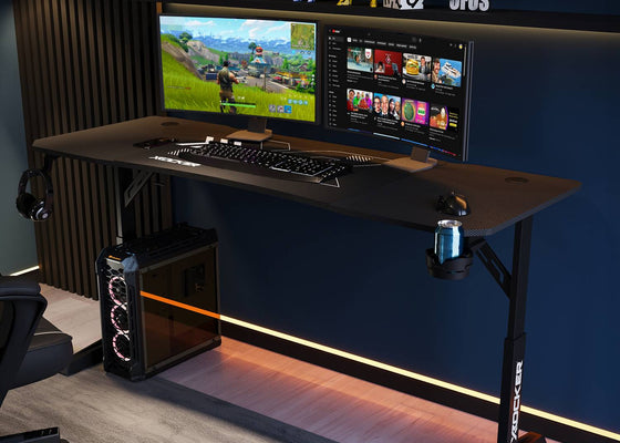 Gaming setup with a Cougar XL Height Adjustable desk, computer monitors, keyboard, and gaming chair in a dark room.