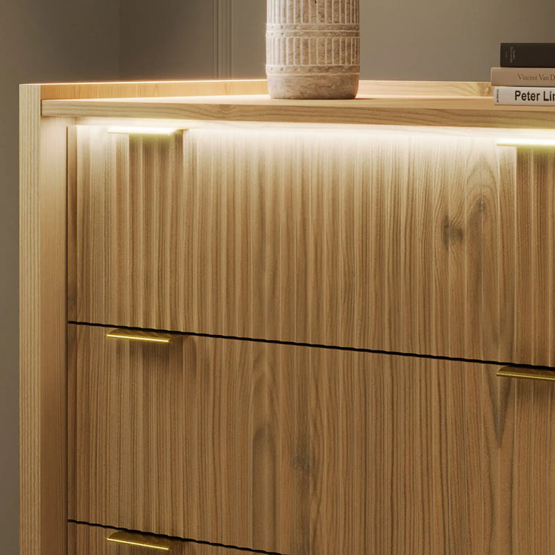 Wooden cabinet with two drawers and a light fixture on top, against a neutral background.