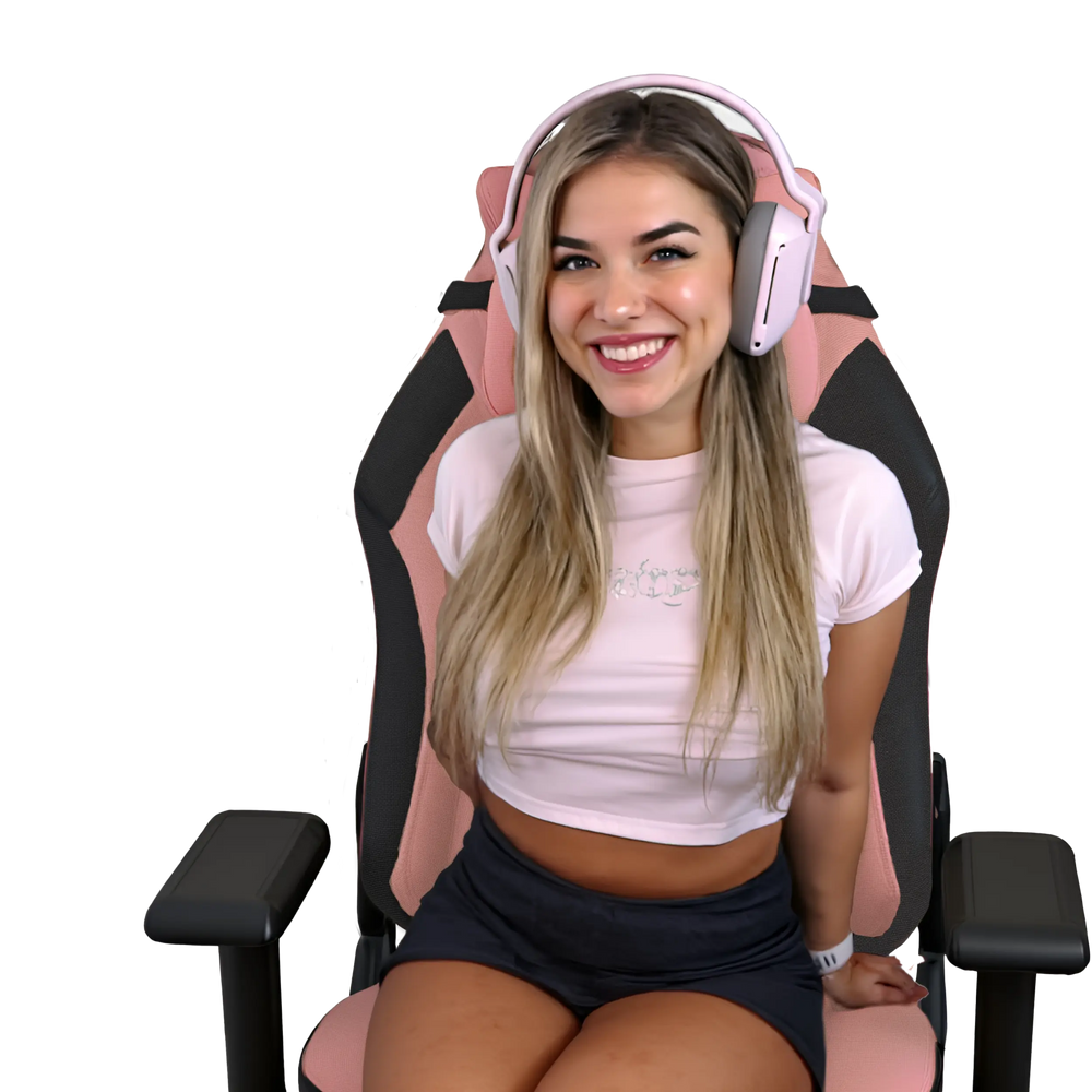 Woman sitting on a gaming chair wearing pink headphones against a white background