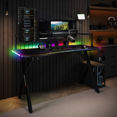 Modern gaming desk setup with RGB lighting in a dark room