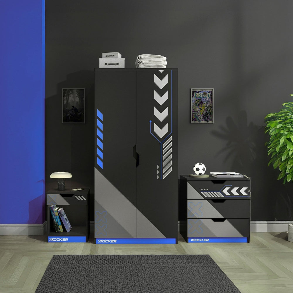 Modern bedroom furniture set with cabinets and drawers in a room with a dark wall and plant.
