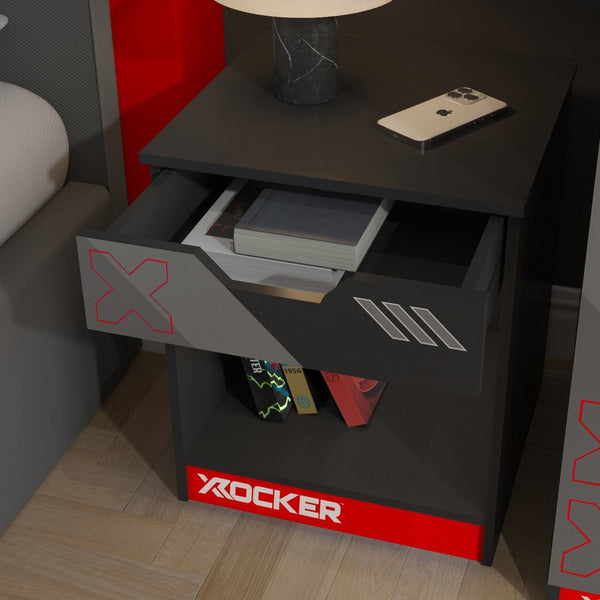 Black nightstand with open drawer displaying items, featuring the 'X Rocker' brand.