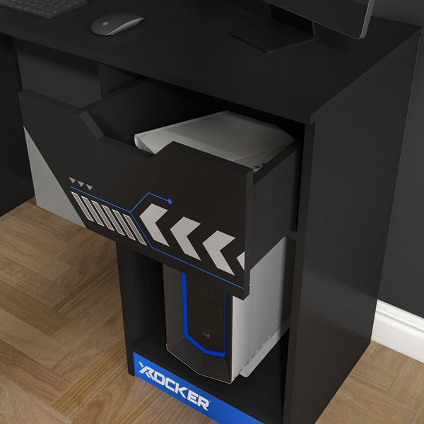 Black gaming desk with open drawer and computer tower, featuring the brand 'X Rocker'.