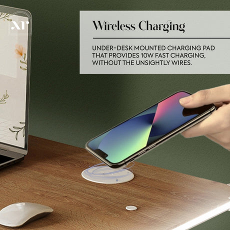 Wireless charging pad on a desk with a phone being charged, laptop, and mouse in the background.