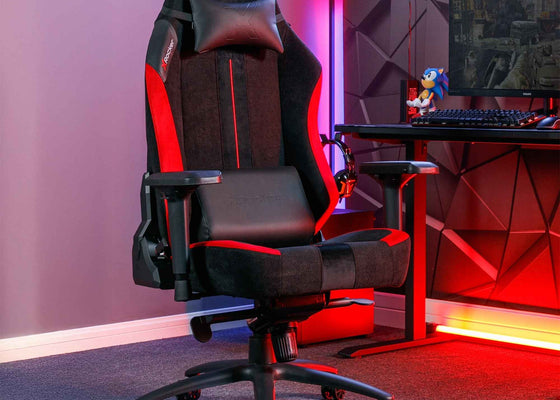 Gaming chair in a room with a desk and computer setup