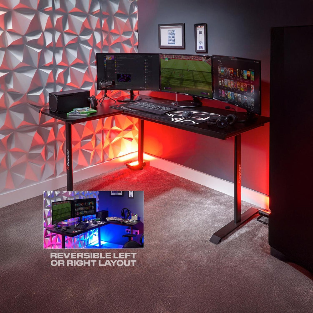 Gaming desk setup with multiple monitors and gaming equipment against a textured wall.