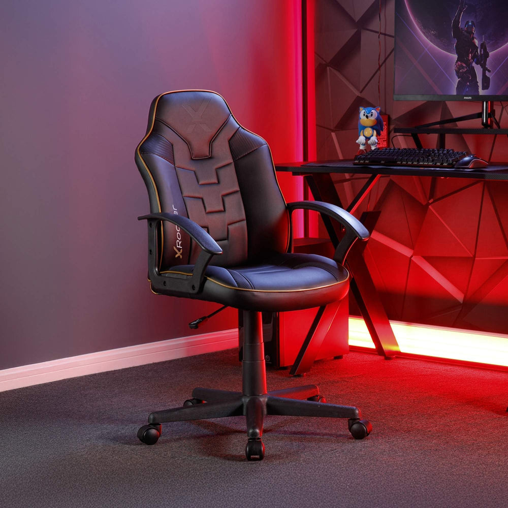 Gaming chair in a room with red lighting and a computer setup.