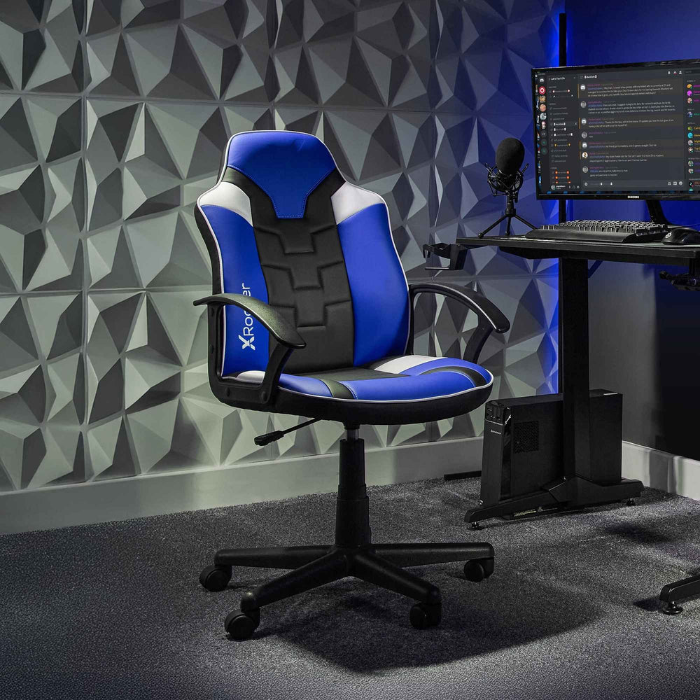 Gaming chair with blue and black design in a room with a geometric wall pattern.