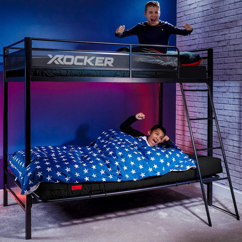 Children playing on a X rocker high sleeper bunk bed with blue walls and brick wall background