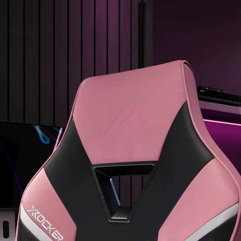 Pink and black gaming chair with X rocker logo in a gaming setup.