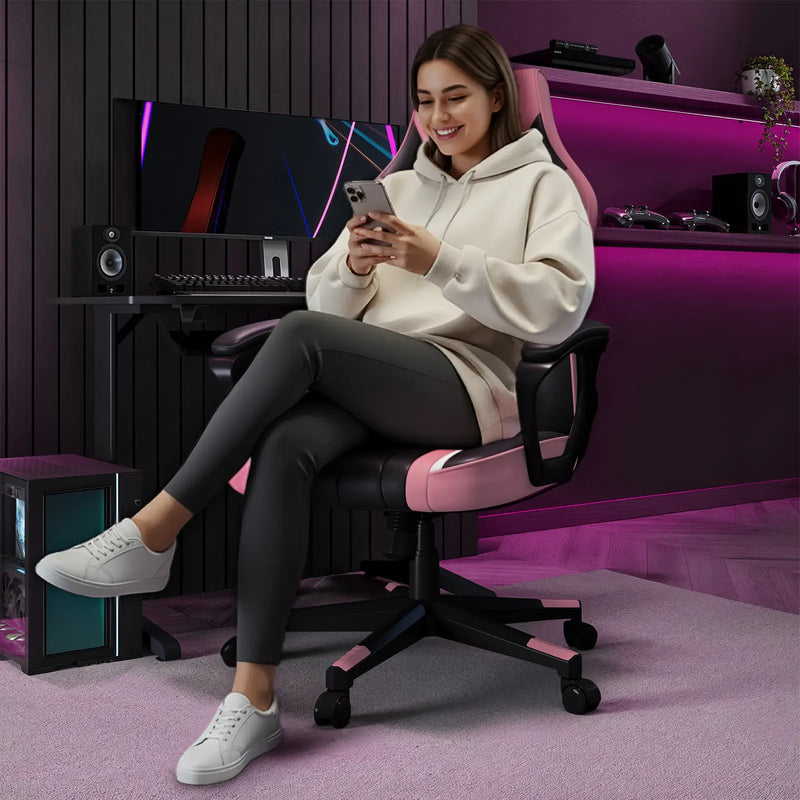 lady sitting on a pink and black gaming chair in a room with gaming setup.