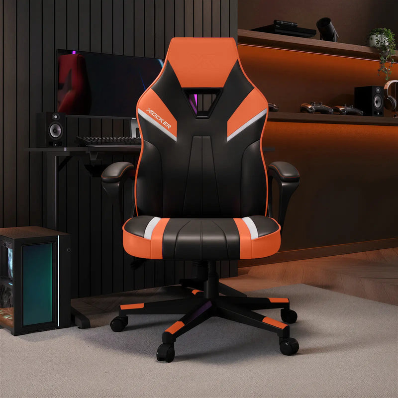 Gaming chair with orange and black design in a room with computer equipment.