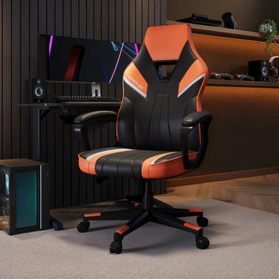 Gaming chair with orange and black design in a room setup with computer equipment.