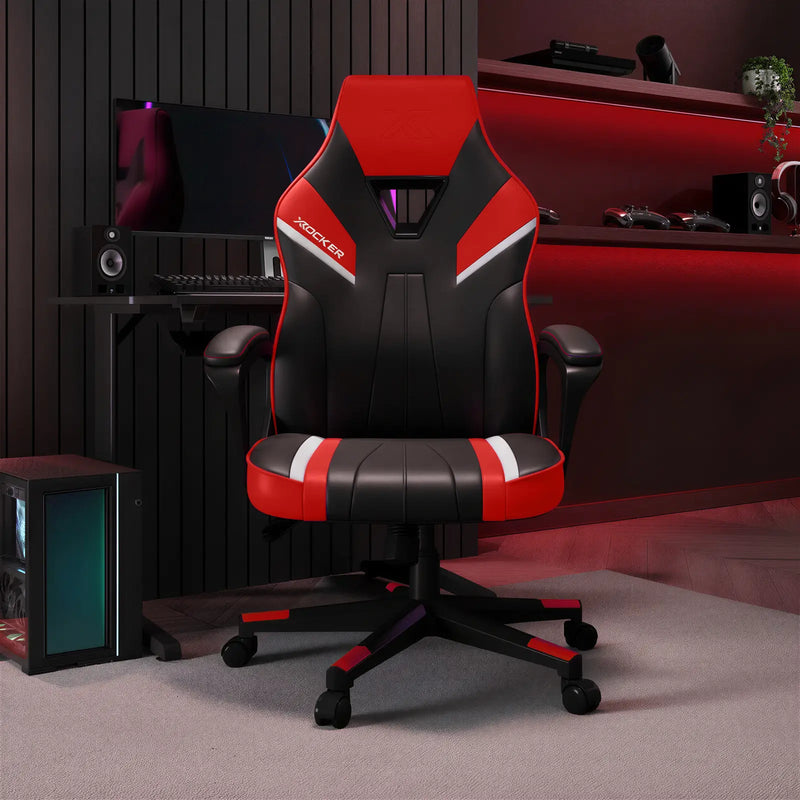 Gaming chair with red and black design in a room with computer equipment.