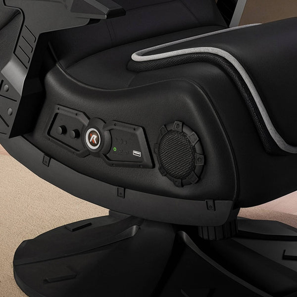 Close-up of a black gaming chair with control panel on a beige background