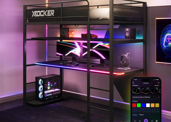 Gaming desk with X rocker branding, illuminated with colorful lights, and smartphone app for control.