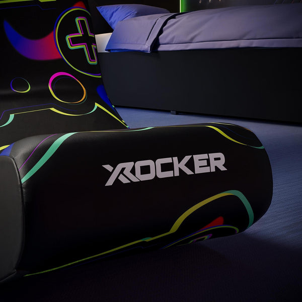 Gaming chair with colorful design and X rocker logo in a dark room.