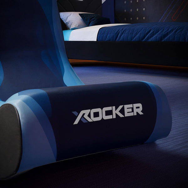 Blue gaming chair with 'X-Rocker' branding in a dark room.