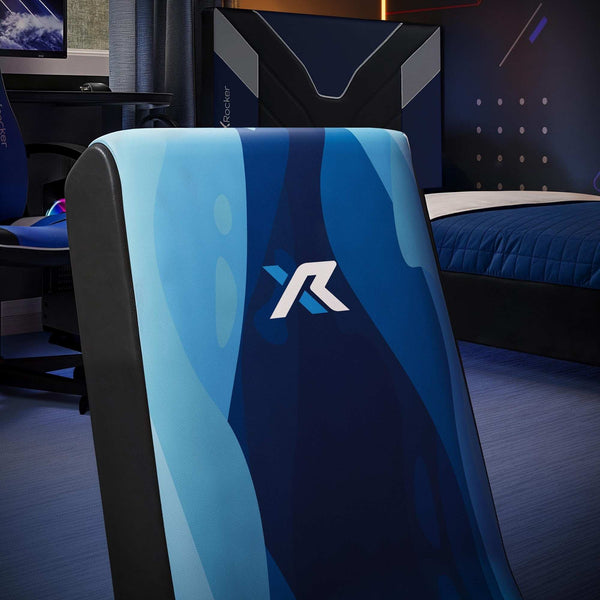 Blue gaming chair with a X Rocker logo in a room setup