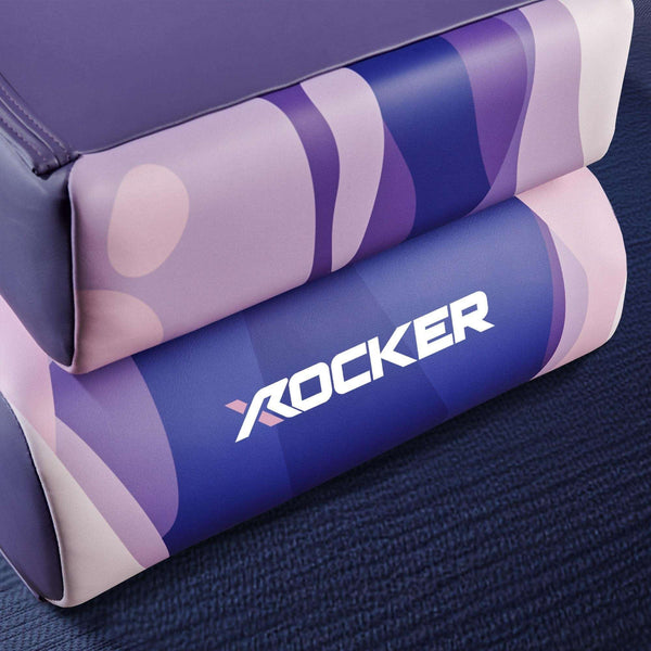 Purple and pink foam roller with 'X ROCKER' branding on a blue surface