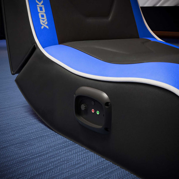 Close-up of a gaming chair with X Rocker branding on a blue textured surface.