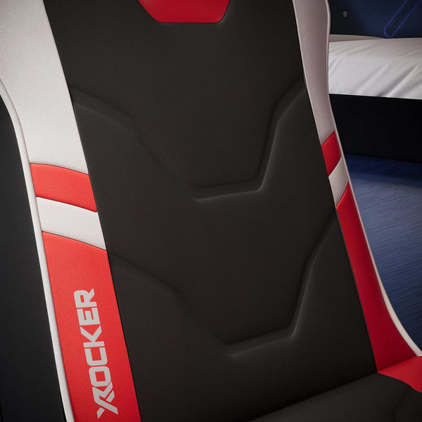 Close-up of a black and red gaming chair with 'X rocker' branding.