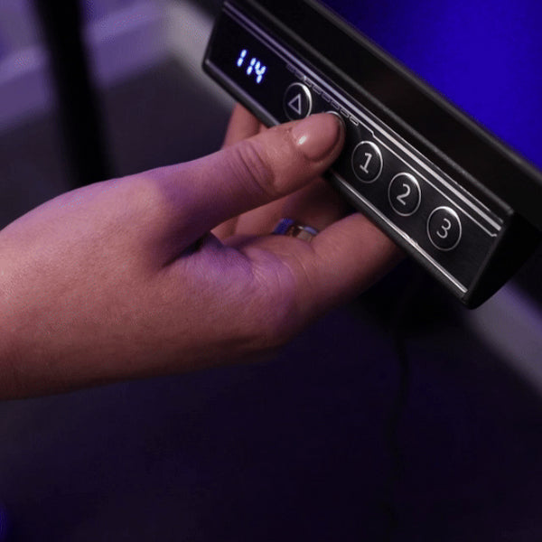 Modern black sit-stand desk with dual monitor setup