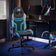 Agility Compact Gaming chair with blue accents in a dark room with computer setup