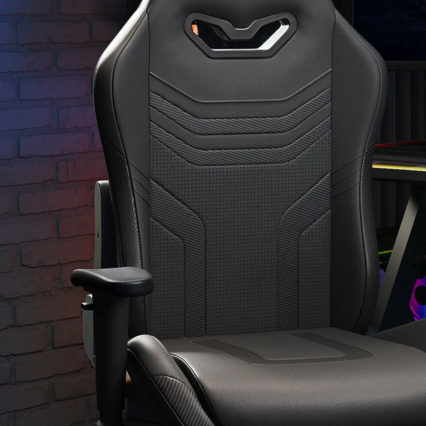 Black gaming chair with ergonomic design against a dark brick wall.