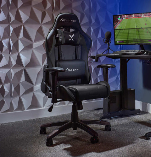 Gaming chair with X rocker logo in a room setup with a computer monitor and desk.
