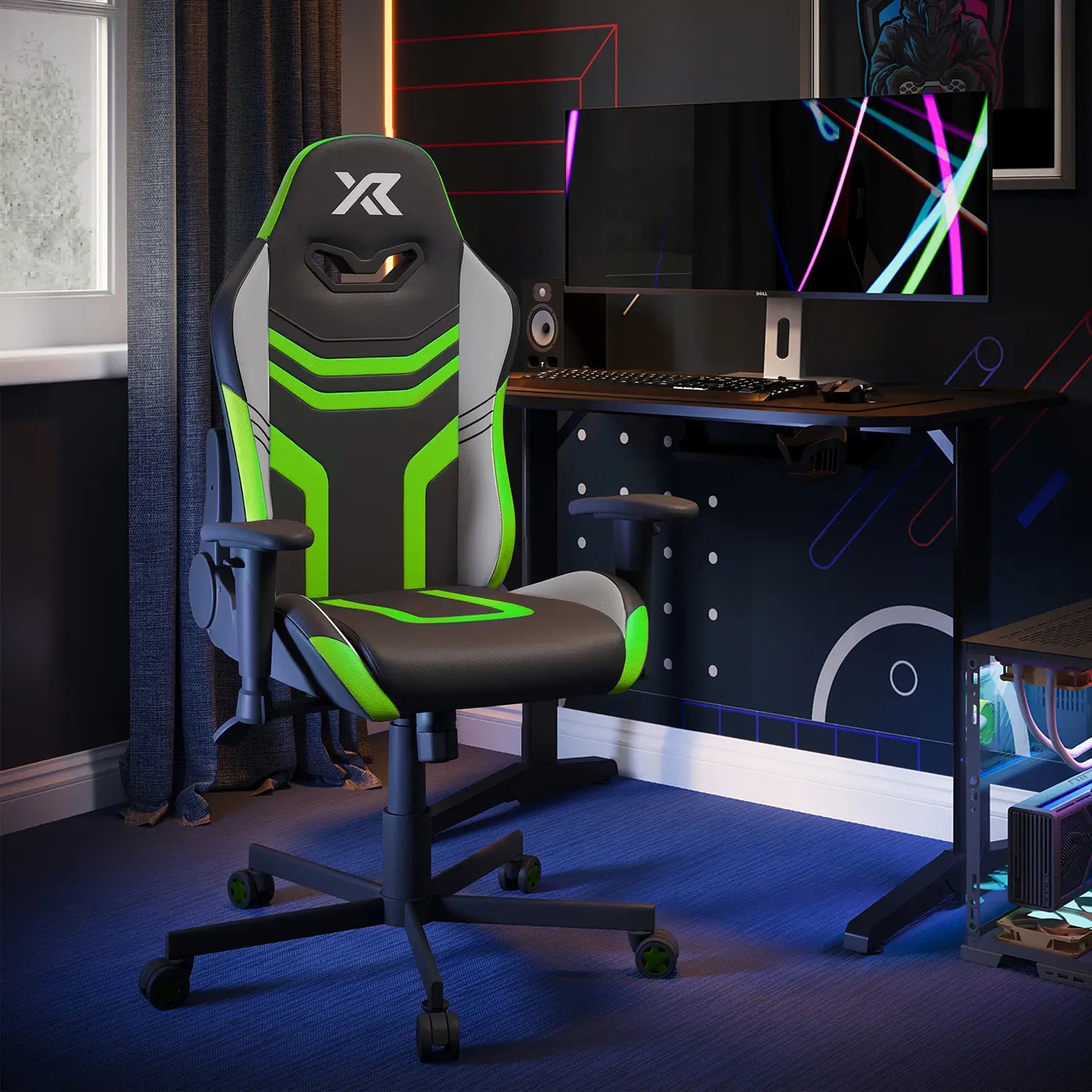 Agility Compact Gaming chair with green accents in a room setup with a computer desk and monitor.