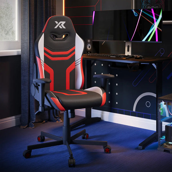 X Rocker Agility Compact Gaming chair with red and black design in a room with a desk and computer setup.