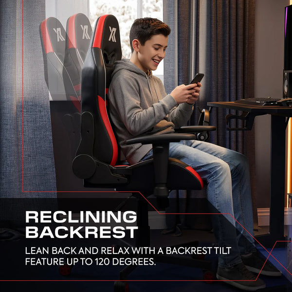 Person sitting in a gaming chair with reclining backrest feature, using a smartphone.
