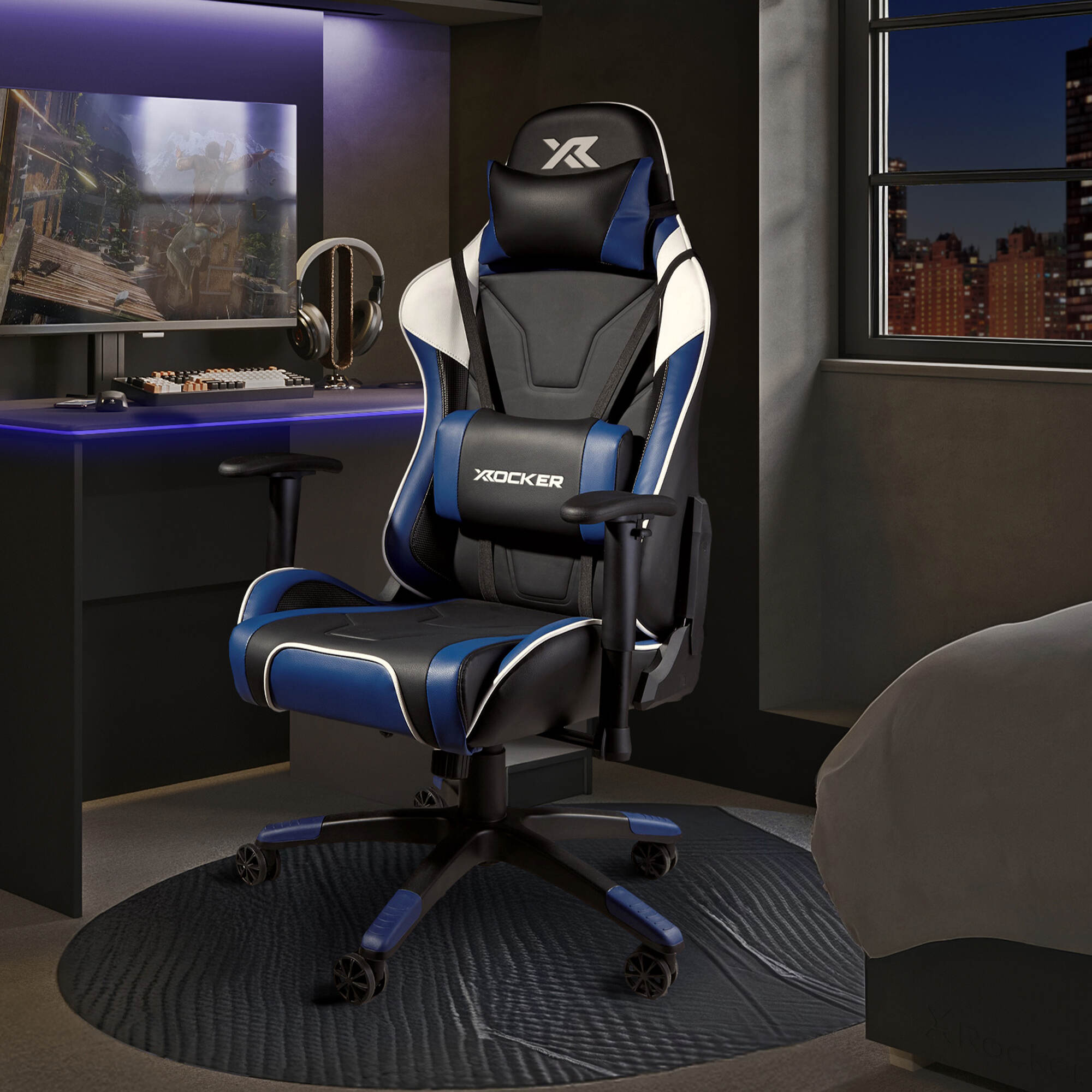 Agility Gaming chair with blue accents in a room setup with a desk and computer monitor.
