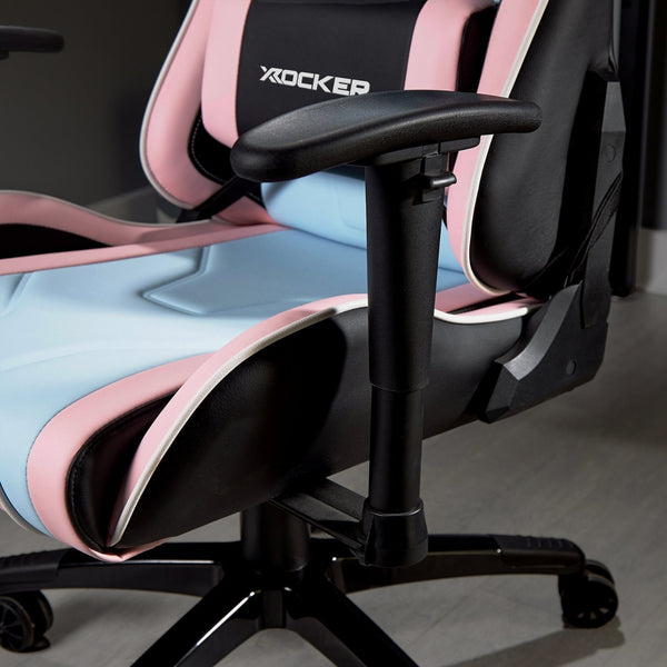 Gaming chair with pink and black design on a wooden floor.