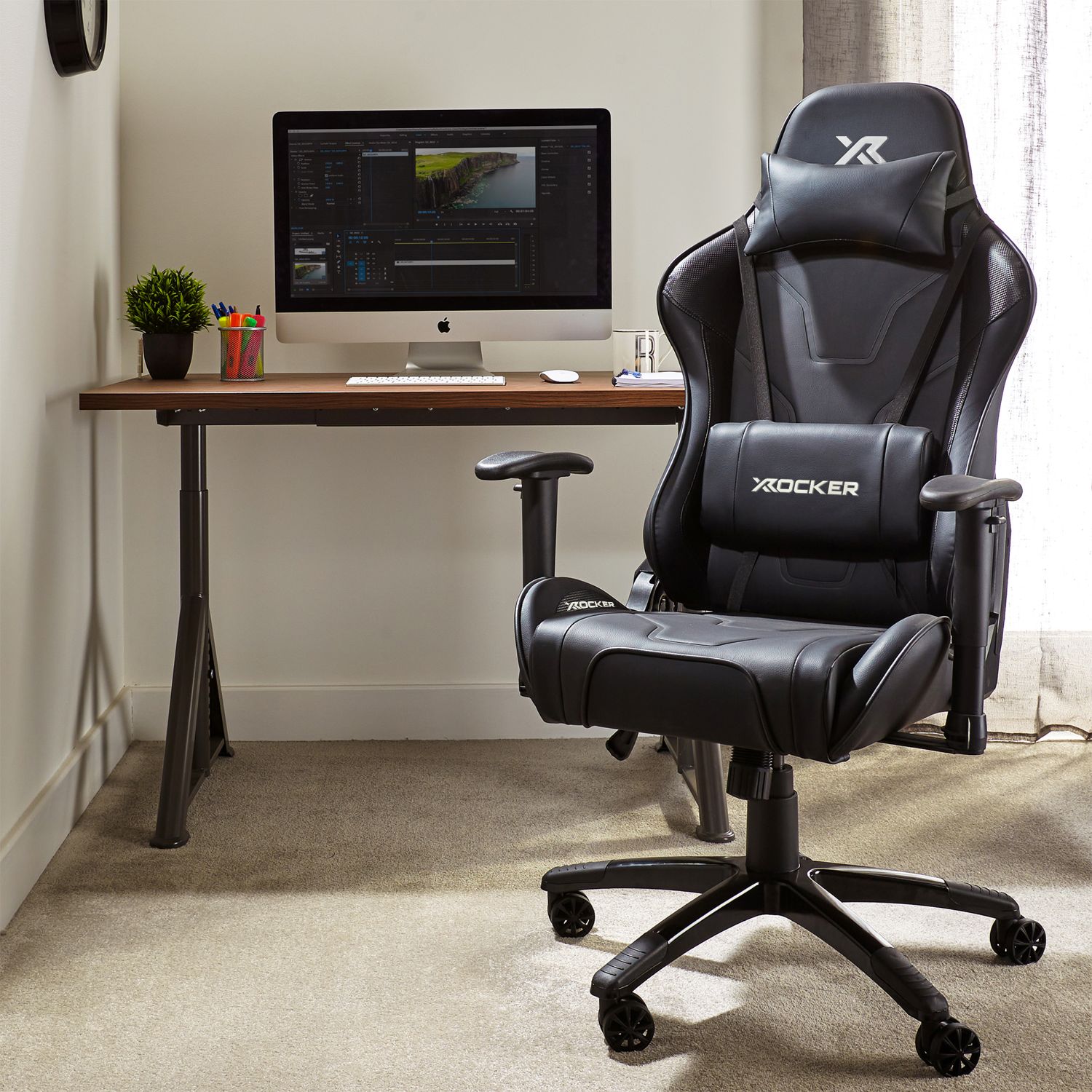 Black gaming chair in front of a desk with a computer setup