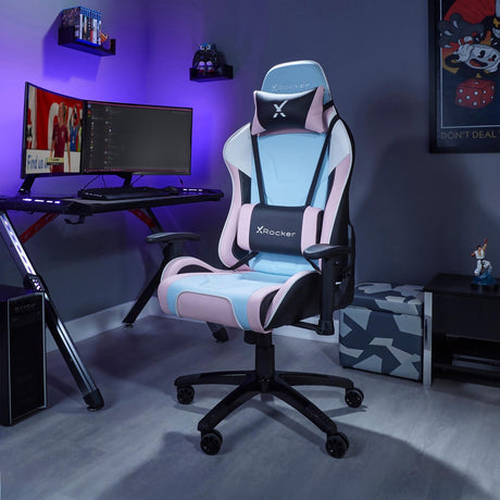 Gaming chair with X rocker logo in a room setup with a desk and computer monitors.