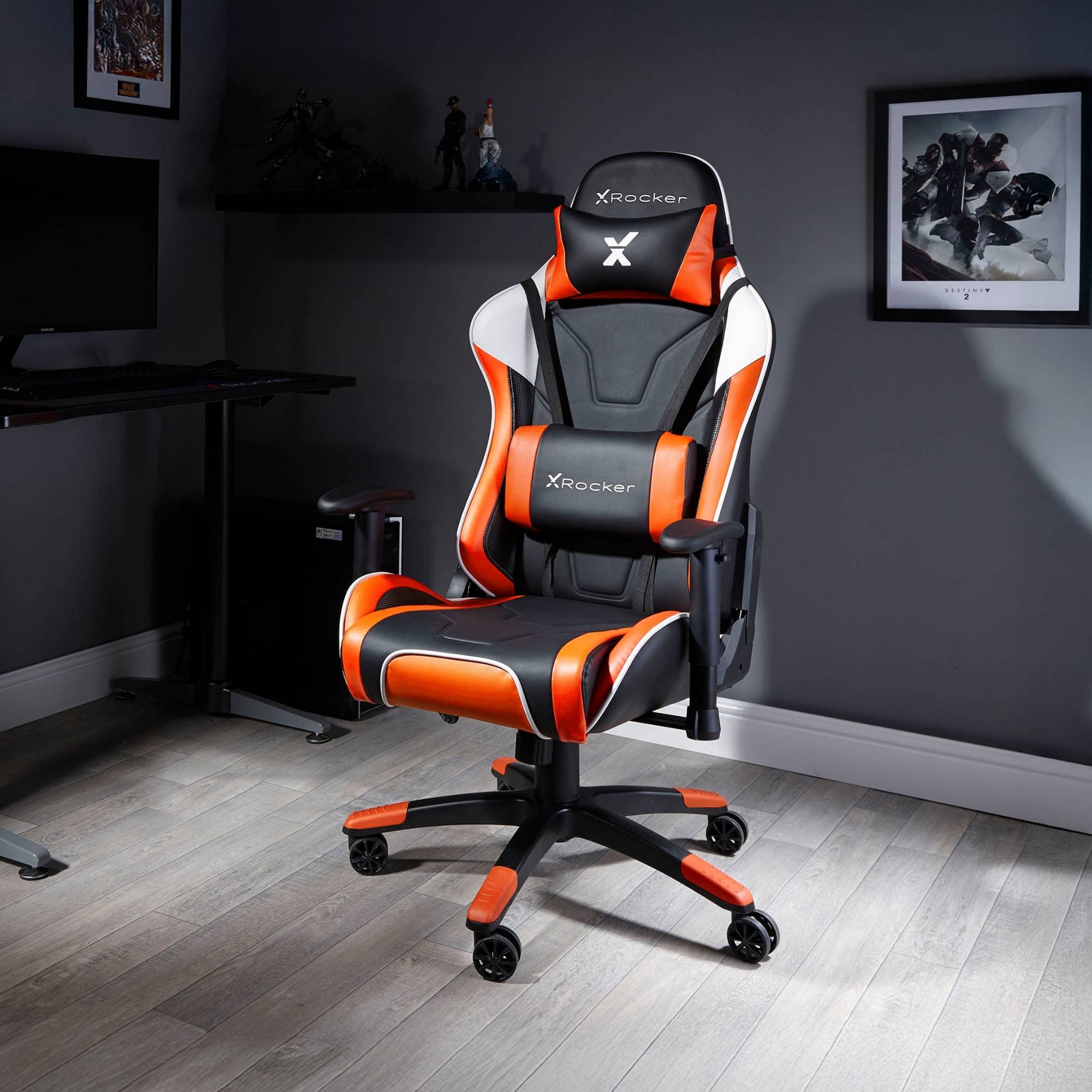 Black and orange gaming chair with X rocker logo in a room setting.