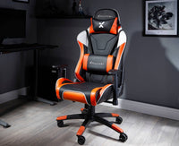 Black and orange gaming chair with X rocker logo in a room setting.