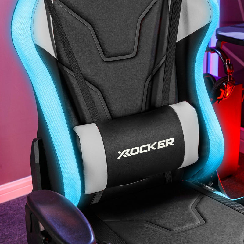 LED Gaming chair with X rocker logo on a blurred gaming setup background
