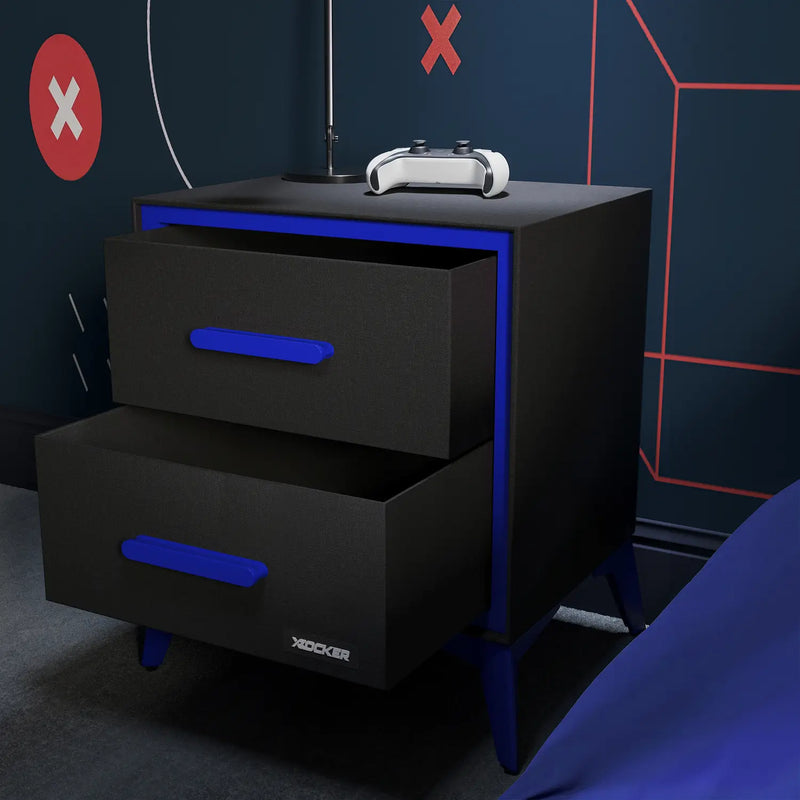 Black nightstand with blue accents and X rocker branding against a dark wall with red 'X' symbols.