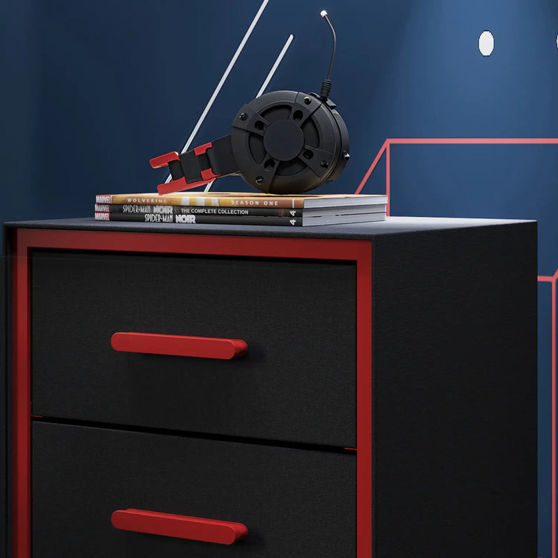 Black dresser with red handles featuring a stack of books and headphones