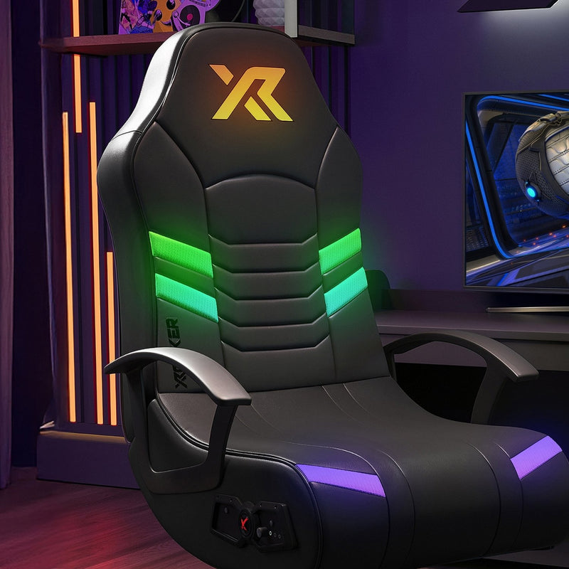 Gaming chair with RGB lighting in a room setup with a computer monitor.